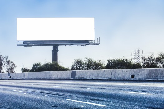 Big white billboard on empty high way ** Note: Visible grain at 100%, best at smaller sizes